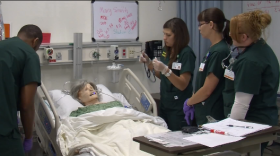 Nursing students work on a computerized medical mannequin at Grossmont Community College, April 2014. 