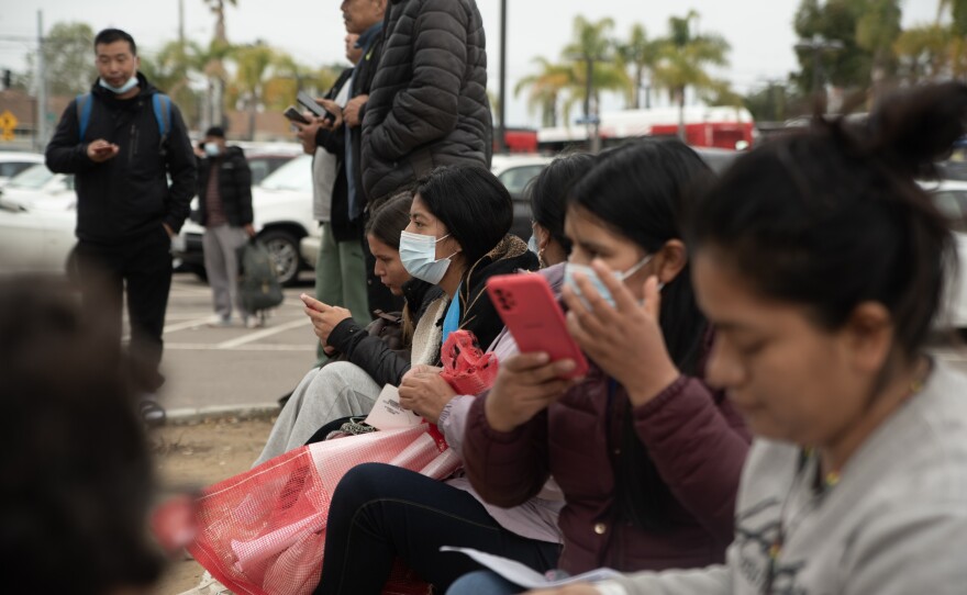 Migrants and asylum seekers call friends and relatives after Customs and Border Protection releases them from custody in San Ysidro, April 19, 2024.