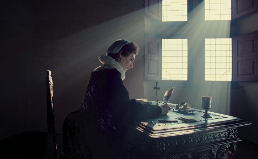 Actress portraying Mary, Queen of Scots writing her coded letters.