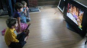 Mac, left, Veronica and Petra Humphrey watch the PBS children's channel on their parents' high definition television.