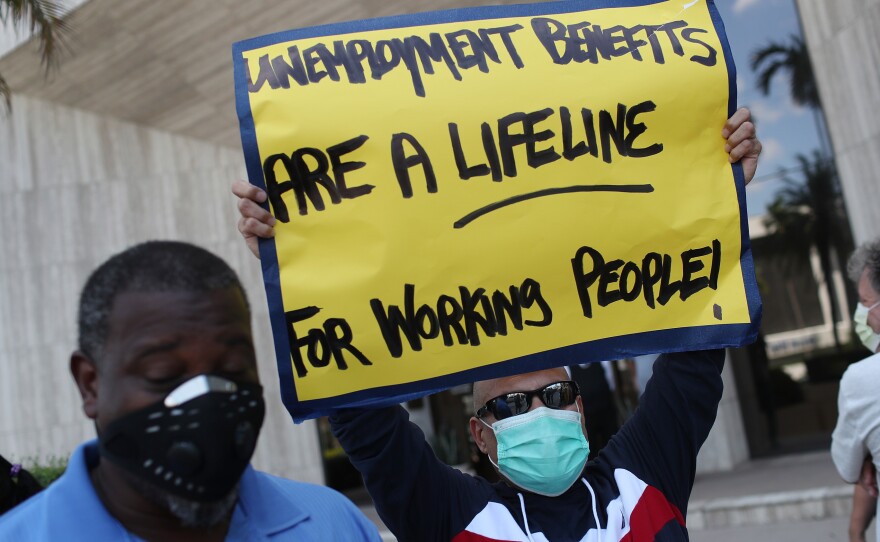 On Thursday in Miami Springs, Fla., demonstrators ask senators to support the continuation of boosted unemployment benefits.