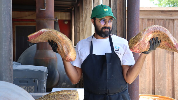 Zain Shafi prepares to put briskets in the smoker at Goldee's BBQ in Fort Worth, Texas.
