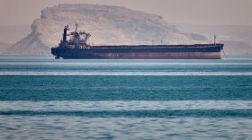 A bulk cargo ship sits at anchor in the Strait of Hormuz off Bandar Abbas, Iran, Saturday, May 2, 2026.
