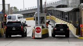 Vehicles cross over to Mexico at the Gateway International Bridge, Friday, March 20, 2020, in Brownsville, Texas. 