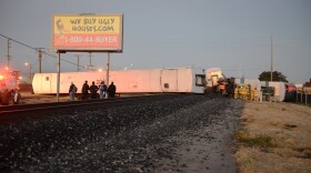 Firefighters attend to injured passengers at the scene of a Metrolink collision in Oxnard, Feb. 24, 2015. Three cars of a Southern California Metrolink commuter train have derailed and tumbled onto their sides after a collision with a truck on tracks in Ventura County, northwest of Los Angeles.