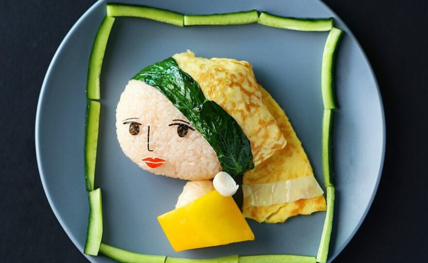 Lee's take on Vermeer's Girl with a Pearl Earring, made of onigiri (white rice wrapped in nori, or seaweed), with cabbage and choy sam, an omelette and yellow capsicum. The lips and earring are crafted from crab stick.