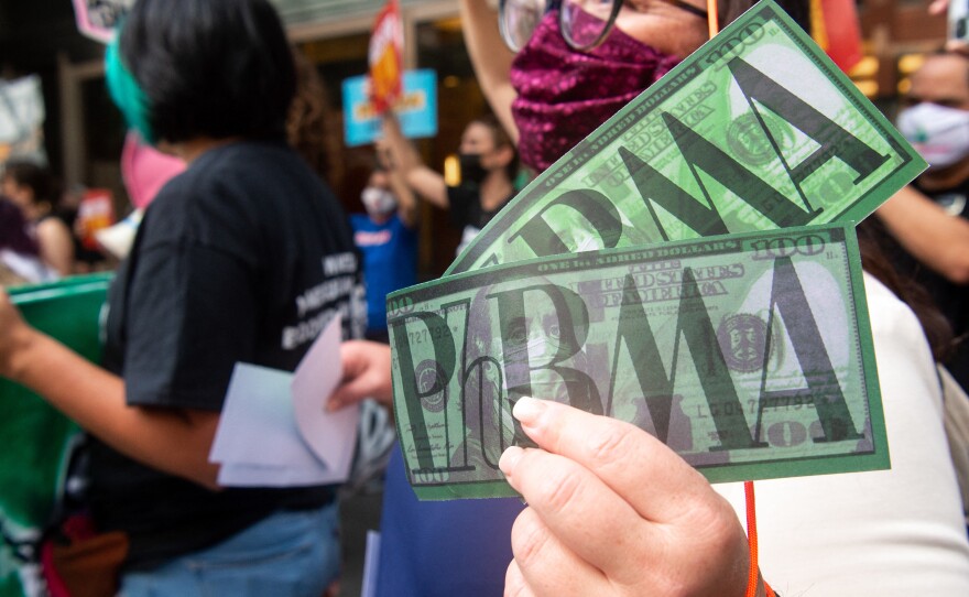 Demonstrators outside PhRMA headquarters in Washington, D.C., protest lobbying by pharmaceutical companies to keep Medicare from negotiating lower prescription drug prices.