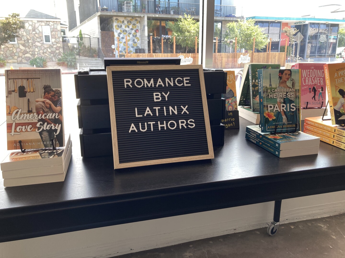 In this undated photo taken inside Meet Cute, a sign advertises a selection of romance novels written by Latinx authors.