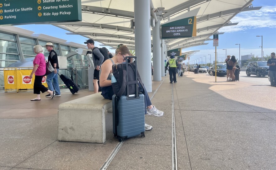 Passengers get in and out of cars at the San Diego International Airport, Oct. 9 , 2025.