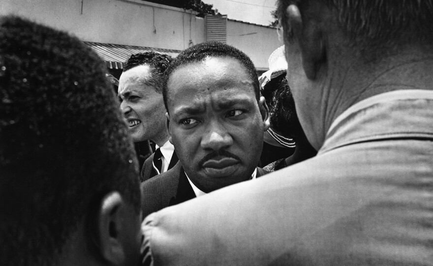 Martin Luther King, Jr. being confronted by Jackson, Miss. police during the funeral march for slain Miss. NAACP leader Medgar Evers, June 1963.
