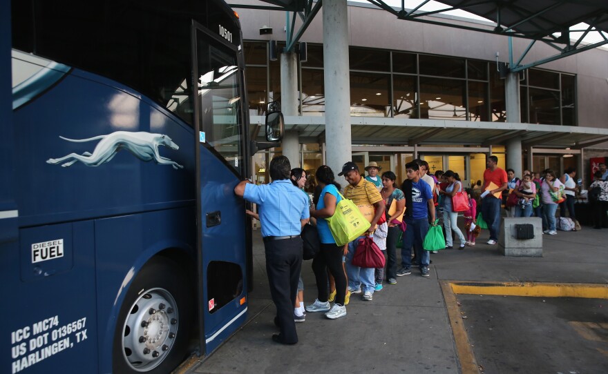 Central American immigrants just released from U.S. Border Patrol detention board a bus for Houston and then other U.S. destinations on July 25, 2014, in McAllen, Texas. Federal agencies have been overwhelmed by tens of thousands of immigrant families and unaccompanied minors from Central America crossing illegally into the U.S.