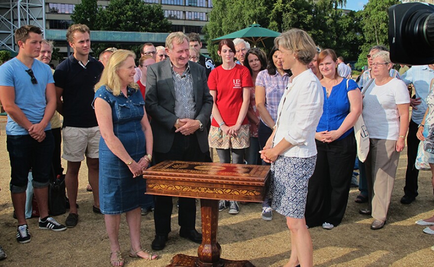 An Irish marquetry games table is seen by Elaine Binning (right).