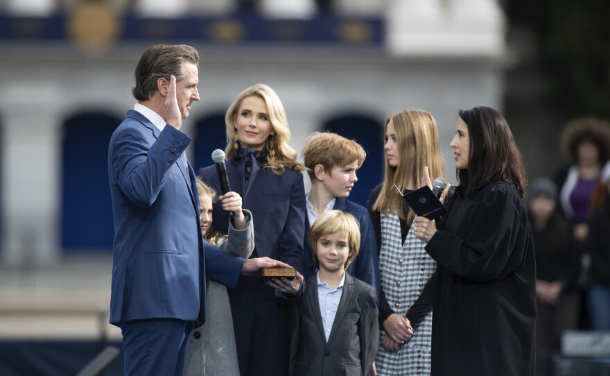 Jennifer Siebel Newsom and the first family watch Chief Justice Patricia Guerrero swears in Gov. Gavin Newson during the governor's inauguration in the Plaza de California in Sacramento, Calif., Friday, Jan. 6, 2023.
