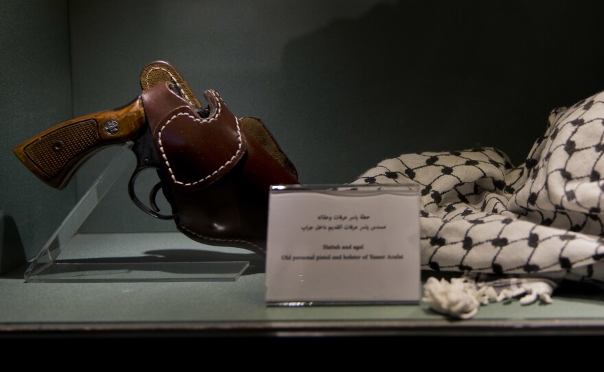 Personal items that belonged to Yasser Arafat, including his pistol and keffiyeh, are displayed in the museum.