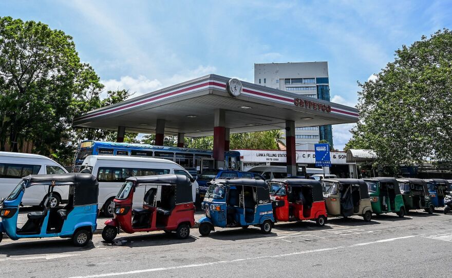 Autorickshaws are lined up to get fuel in Colombo, Sri Lanka, on Monday. COVID and energy price spikes have exacerbated deep-seated economic problems in the country.