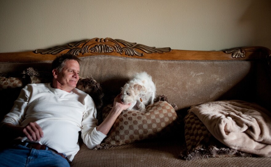 Schiller spends time with his yorkie-doodle Maxine at his apartment. As a result of his mounting medical bills and his inability to work, he says he's now "next to poverty."