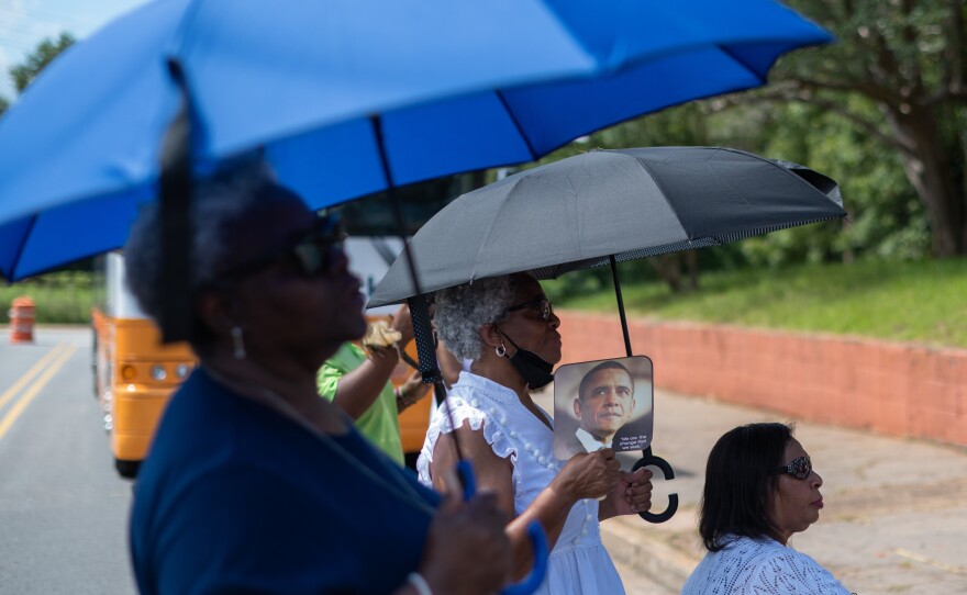 Women listen as U.S. Sen. Raphael Warnock speaks in Americus, Ga., on Aug. 29, 2022.