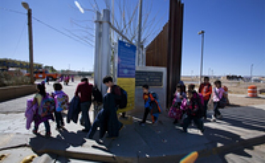 Mayor Skinner lets children off the bus on the New Mexico side of the border, right, where they cross to waiting family members on the Mexico side, in the town of Palomas, left.