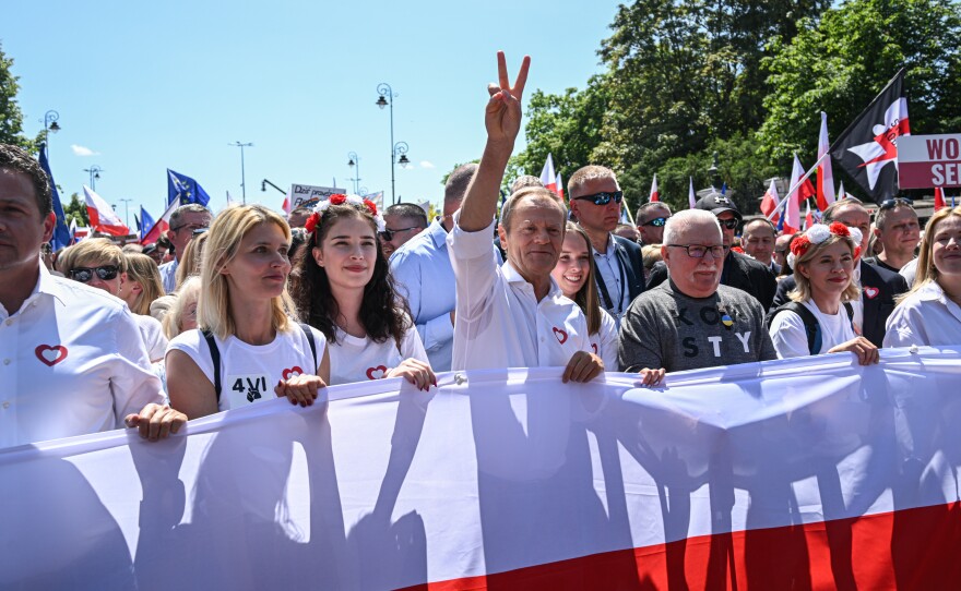 Donald Tusk (center), then in the opposition, marches with Warsaw Mayor Rafal Trzaskowski (left) and former President Lech Walesa (right) in a protest last year organized by Civil Platform, the coalition of political parties now running Poland's government.