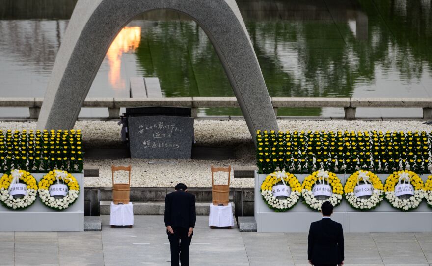 Japanese Prime Minister Shinzo Abe bows in front of a memorial to people who were killed in the 1945 atomic bombing of Hiroshima.