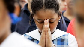 Alexandria McPherson, 8, prays during a National Day of Prayer gathering at City Hall in San Antonio in 2007.