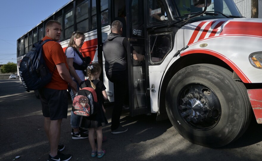Ukrainians board a shuttle from the shelter to Tijuana's border crossing with San Diego. The United States is allowing Ukrainians fleeing the war temporary admission on humanitarian grounds.