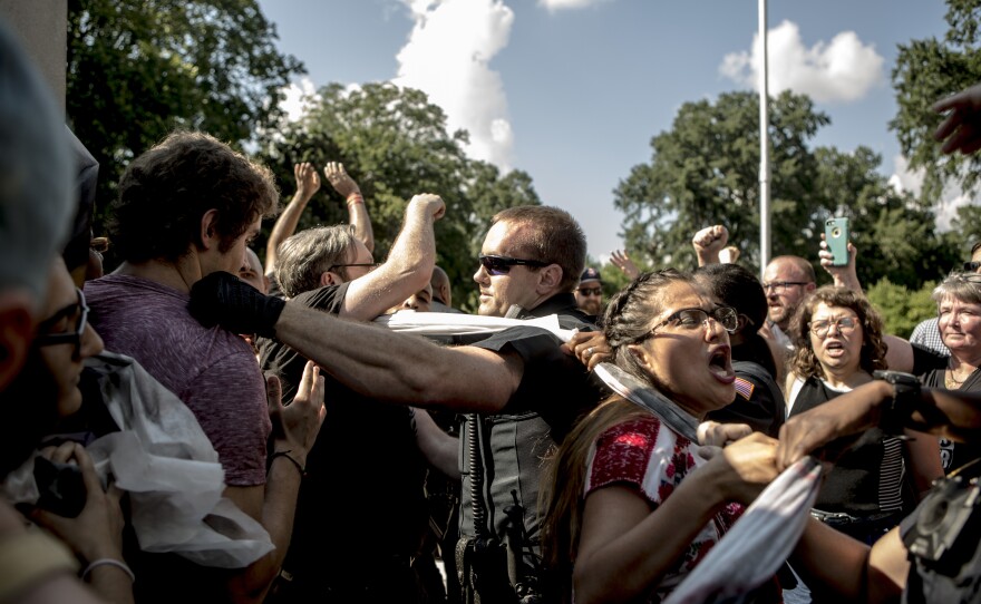 Protesters and the police struggle in August 2017 after officers tore down banners that demonstrators attempted to hang on a statue of Nathan Bedford Forrest in Memphis.