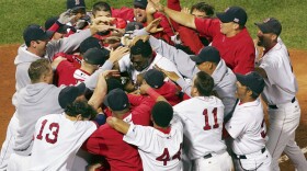 The Boston Red Sox' David Ortiz is mobbed by teammates after his game-and series-winning 10th-inning home run against the Anaheim Angels in their 2004 American League Division Series.