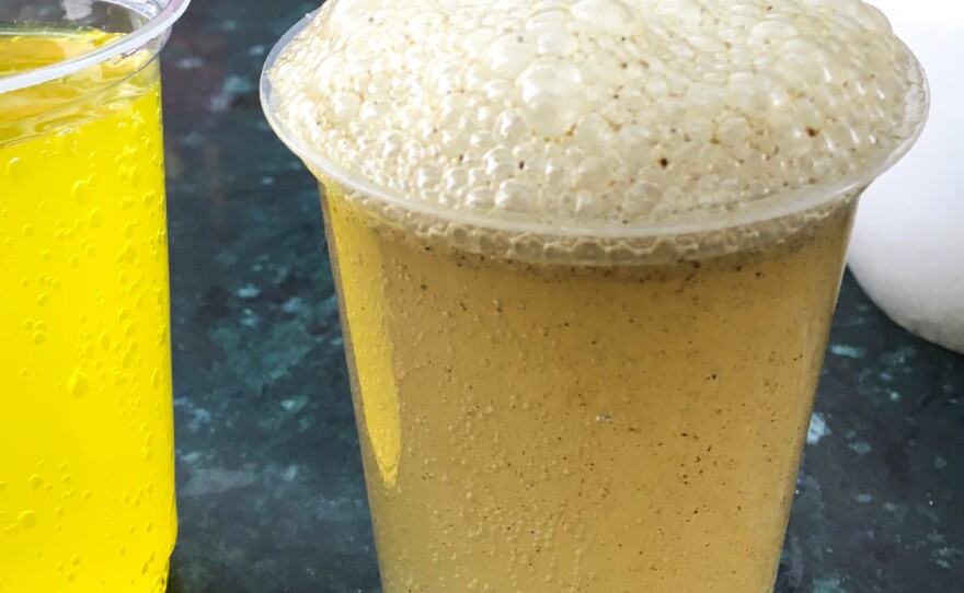 A glass of nimbu masala soda, made with fresh lemon or lime juice and spices.