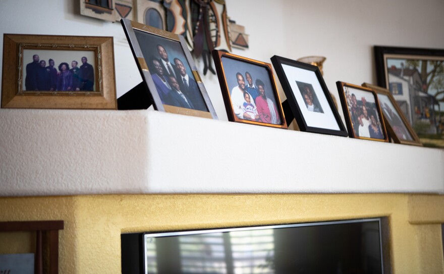 Family photos fill the living room of the Fisher home in Spring Valley, Aug. 16, 2022.