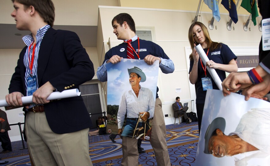 Members of the college group Young Americans for Freedom roll up Ronald Reagan posters to hand out at CPAC in National Harbor, Md., in 2013.