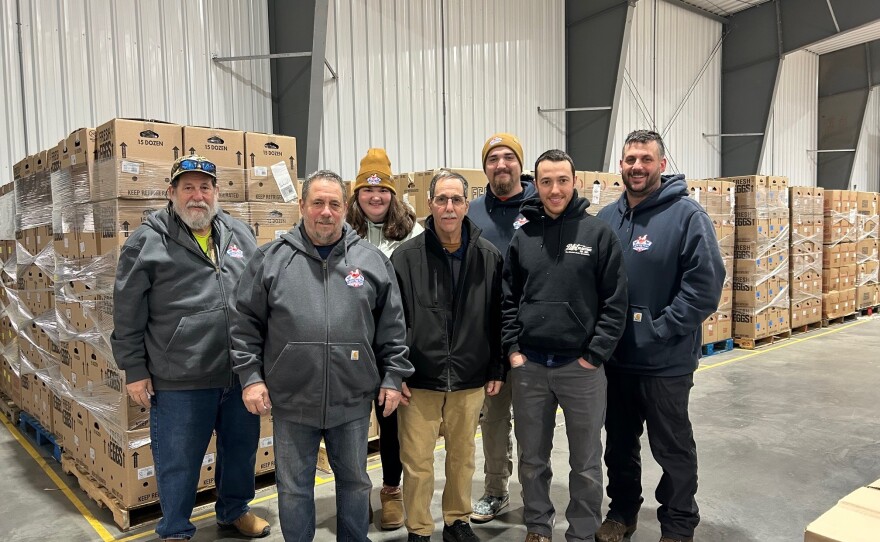 Mike Puglisi (second from left) and his family lost 80% of their egg-laying chickens to avian flu in 2022. It took the better part of a year to restock their henhouses.