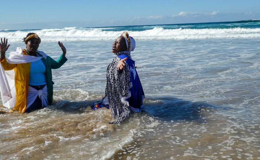 Silungile (right) used a tripod and a timer to capture this moment of attempting to commune with her ancestors. She is dancing with her sangoma (traditional healer) in Durban, South Africa, and has lived with HIV for many years.