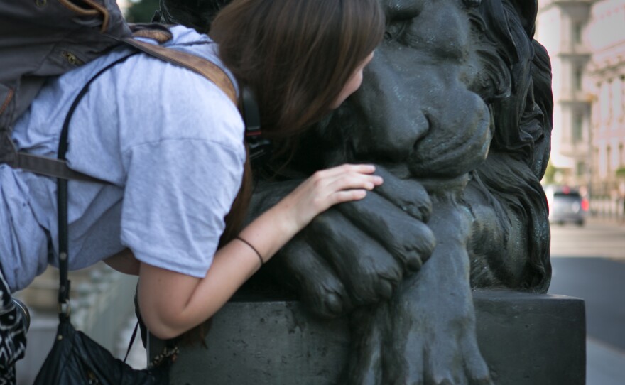 Goodbye kiss: Corcoran College of Art + Design student Gen Fournier kisses one of the Corcoran's bronze Canova Lions.