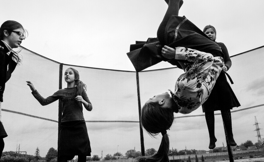 Girls play on a trampoline in 2016 during a break between classes in the village of Anatevka, Ukraine. They're among the thousands of Ukrainians who fled their homes in the Donbas region of eastern Ukraine, where intense fighting took place.