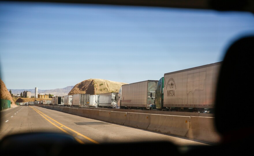 Dozens of 18-wheelers line up to cross the Nogales border, heading into the U.S.