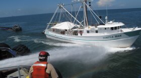 A shrimp-trawler gets a high-powered spray wash  after spending a day skimming oil in the Gulf of Mexico. The Coast Guard has set up dozens of offshore decontamination stations like this one south of Mobile Bay.