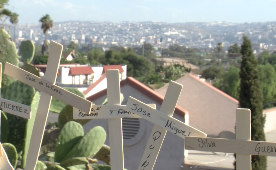 Relatives of deported immigrants placed crosses dedicated to them on a San Ysidro chain-link fence, September 20, 2015. 