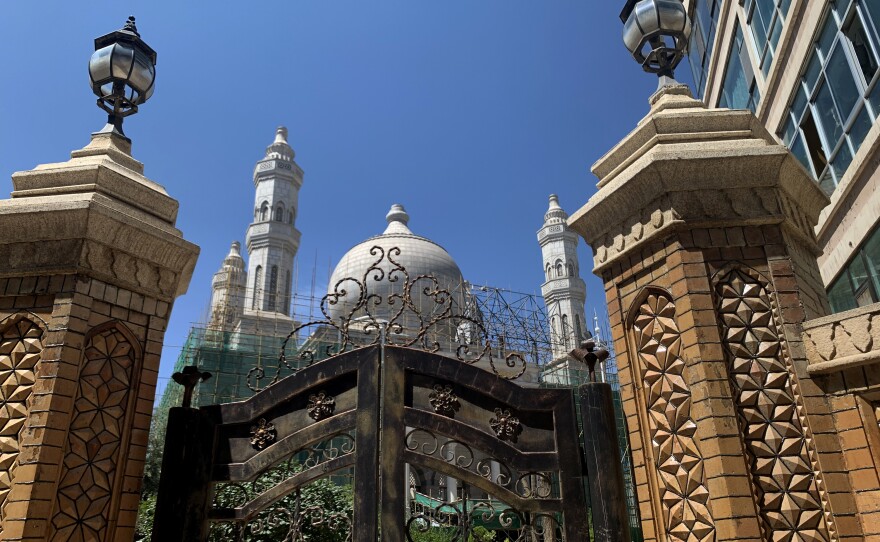 Dome removal preparations are under way at the Nanguan Mosque in Xining city. But China's efforts at cultural control are most heavy-handed in the western region of Xinjiang, where authorities detained hundreds of thousands of ethnic Uyghurs in camps. Beijing says the camps are schools that teach the Chinese language and Chinese communist theory.