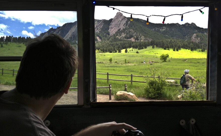 Banjo Billy guides the bus through Chautauqua Park, home to Boulder's signature Flatirons rock formation. The park is also home to mischievous tales of rock climbers gone wild.