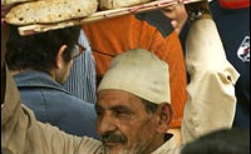 A vendor carries a rack of bread in the Nile Delta city of Mahalla, Egypt, north of Cairo, on April 6, 2008. The country is in the grip of a serious bread crisis brought on by the rising cost of wheat.