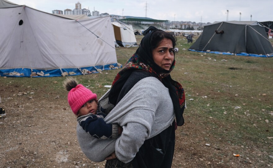 A mother, Zehra Cati, with her young child at a makeshift camp for people displaced by the earthquake.