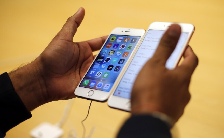 A customer tries out a new iPhone at an Apple store in Chicago. The FBI is working with a "third party" to test a method of seeing what's inside the iPhone used by one of the San Bernardino shooters without Apple's help.