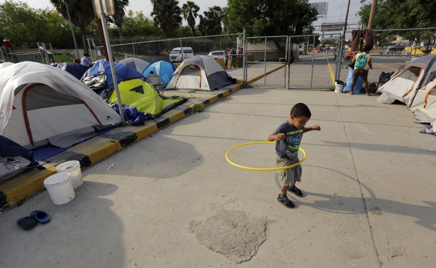 William Linares, a 5-year-old from Honduras, plays in an encampment where he is living near the international bridge in Matamoros, Mexico, on April 30. The boy is traveling with his mother, Suanny Gomez, and seeking asylum in the United States.