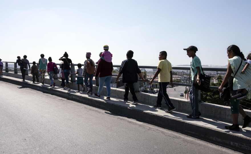 Central American migrants traveling in the Migrant Via Crucis caravan walk to their legal counselling meeting in Tijuana, Baja California state, Mexico, in April.