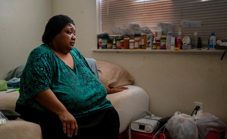 Wilma Banks, who lives in the neighborhood of New Orleans East, sits on her bed next to her nebulizer and CPAP machine. In the aftermath of Hurricane Ida, when much of New Orleans was left without power, she wasn't able to power up the medical devices and had only her limited supply of inhalers to widen her airways.