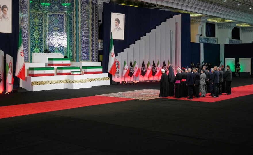 Iranian religious leaders and other mourners pay their respects before the coffins of slain Iranian Supreme Leader Ayatollah Ali Khamenei and members of his family during a viewing ceremony ahead of the dayslong funeral ceremonies at the Imam Khomeini Mosalla Grand Mosque in Tehran, Iran, Friday, July 3, 2026.