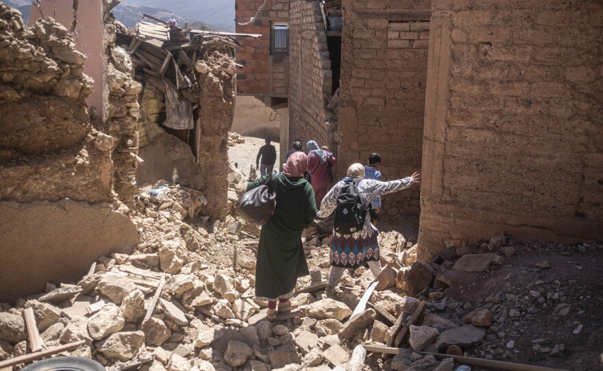 Residents flee their homes after an earthquake in Moulay Brahim village, near the epicenter of the earthquake, outside Marrakech, Morocco, on Saturday.