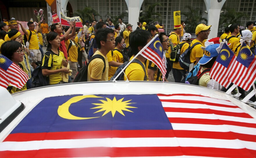 Supporters of a pro-democracy group, Bersih (Clean), march in Malaysia's capital Kuala Lumpur on Saturday. The group was protesting alleged corruption at the top levels of government. President Obama is set to visit and meet the embattled prime minister, Najib Razak, on Friday.