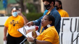Genea Wall, a City Heights resident who was recently approved for San Diego’s rent relief program, speaks at a downtown protest over San Diego Mayor Todd Gloria’s budget proposal, May 25, 2021. The protesters advocated spending more on housing and other community issues.
